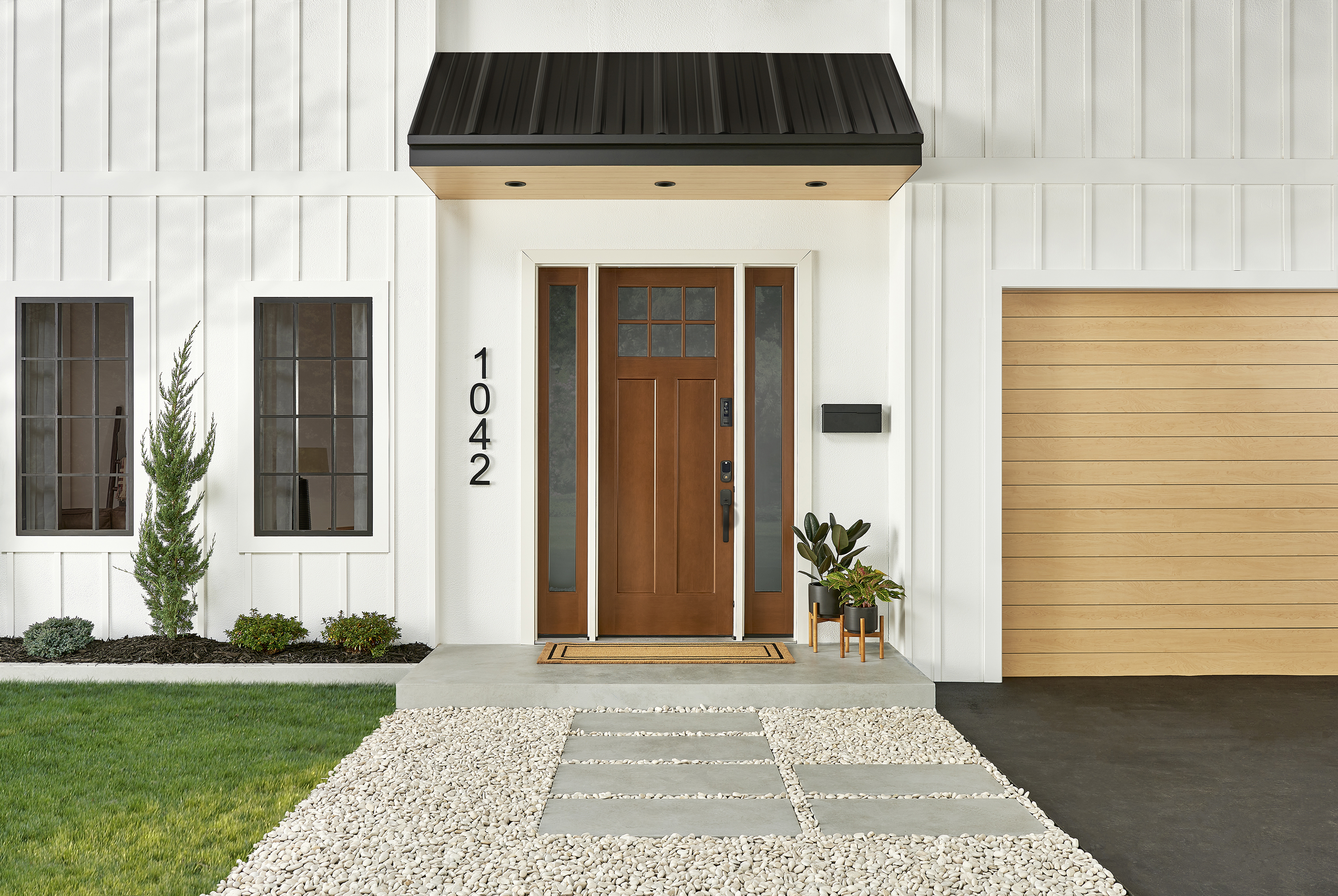 straight on image of a Winslow M-Pwr smart door with 2 side lights on a transitional home
