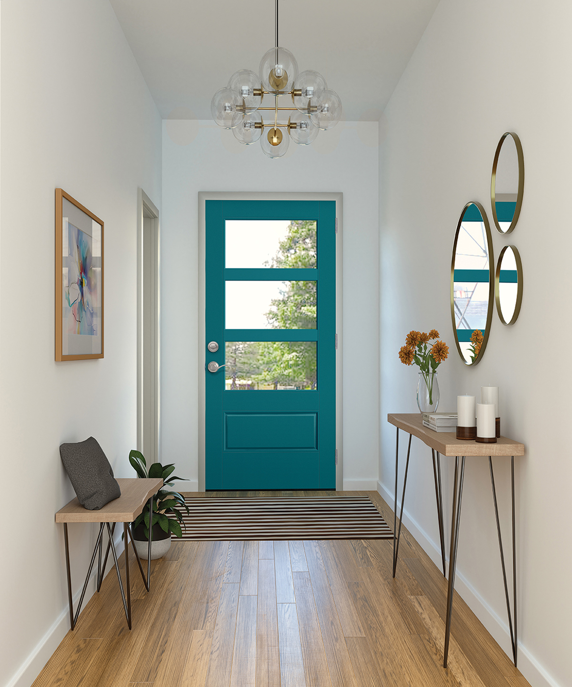 Front view of a hallway with white walls, decorative hanging lights, circular mirrors, two tables, a painting, and a striped black and white doormat leading to a teal 3/4-lite single panel door with glass inserts.